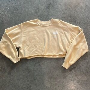 Urban Outfitters cropped graphic sweatshirt. Pale yellow. Kyoto Champions